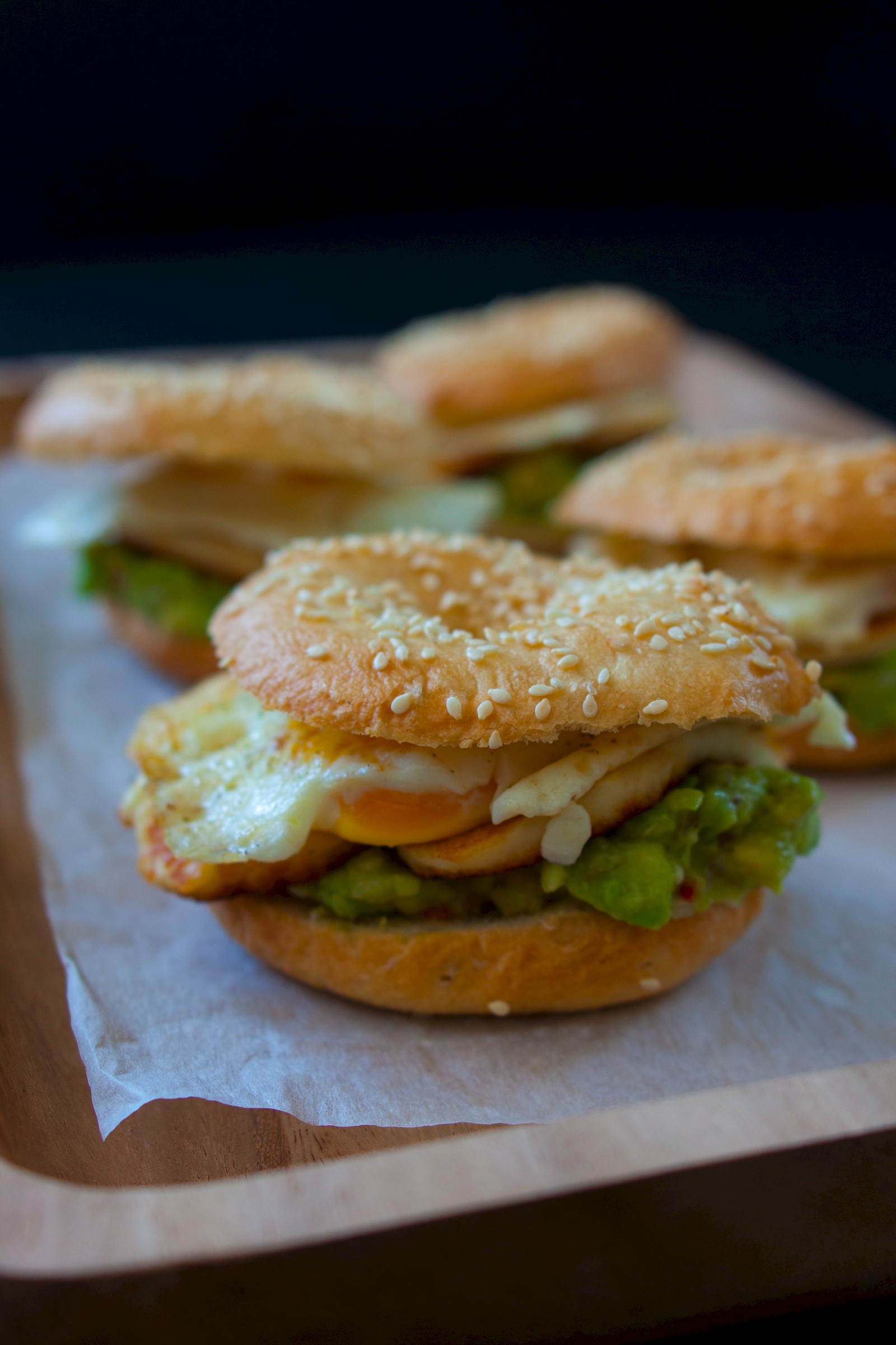 Bagels with avocado, halloumi and eggs sunny-side up