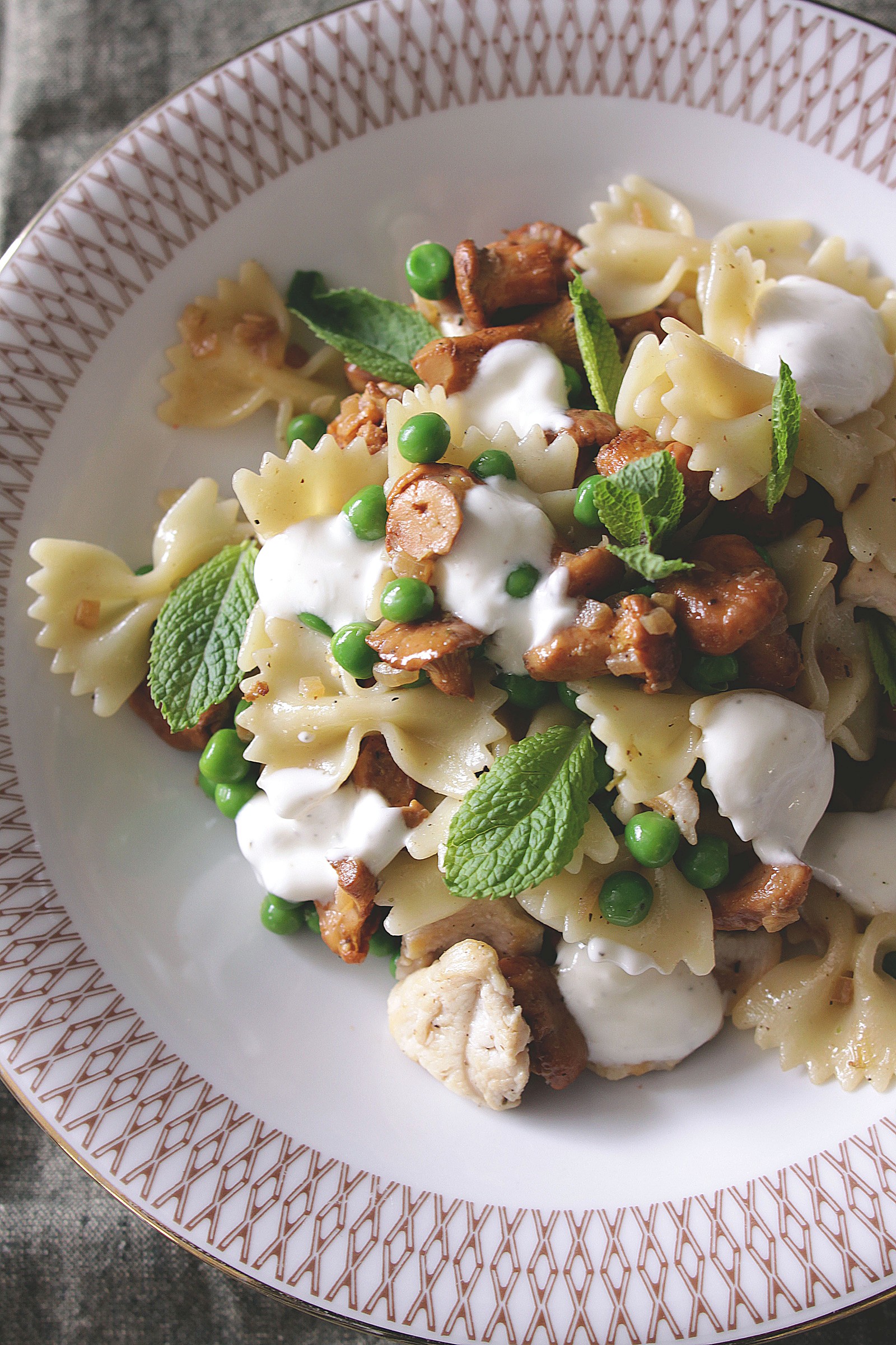 Farfalle with chicken, peas, chanterelles and mint