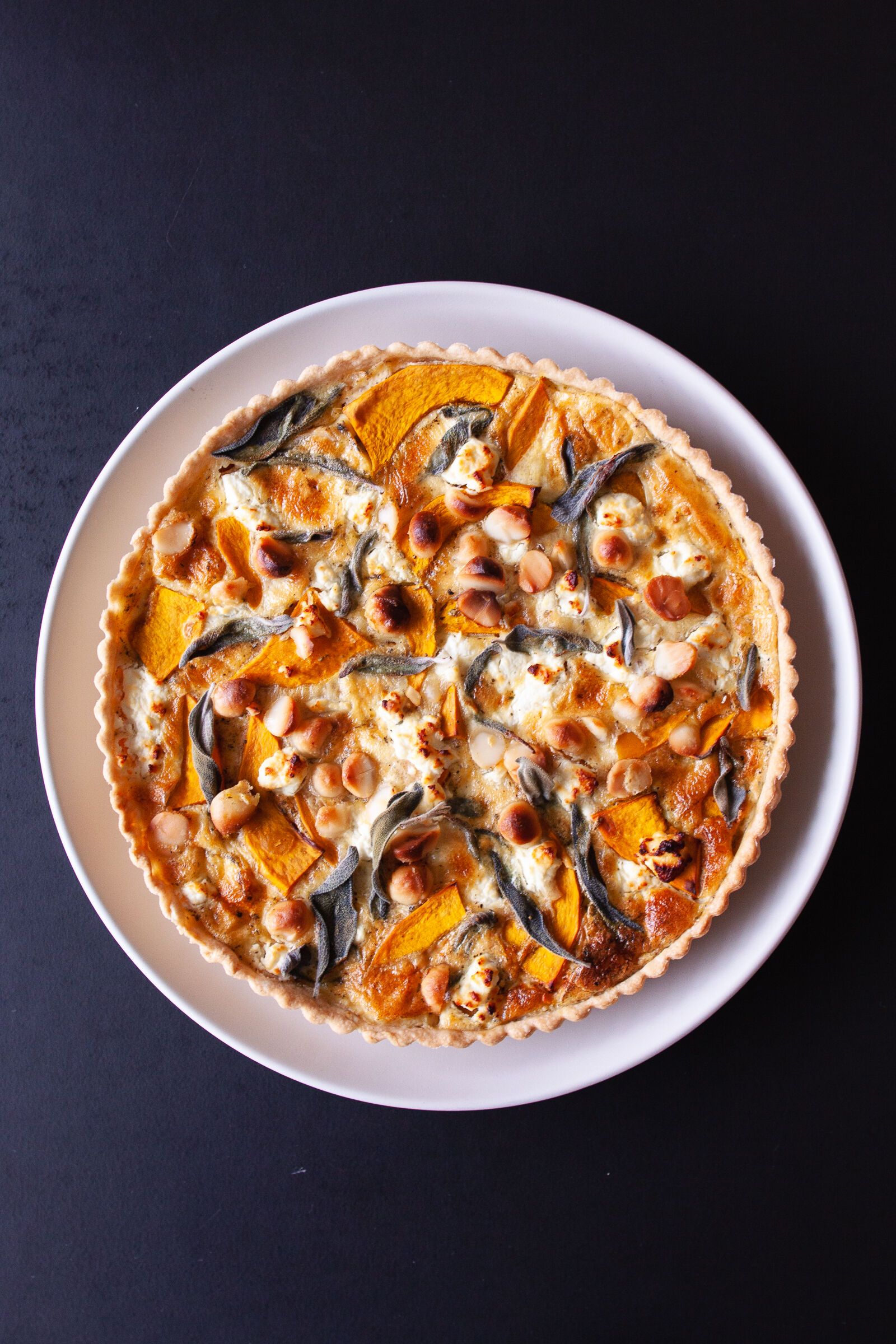 Hokkaido quiche with goat cheese, macadamia and sage