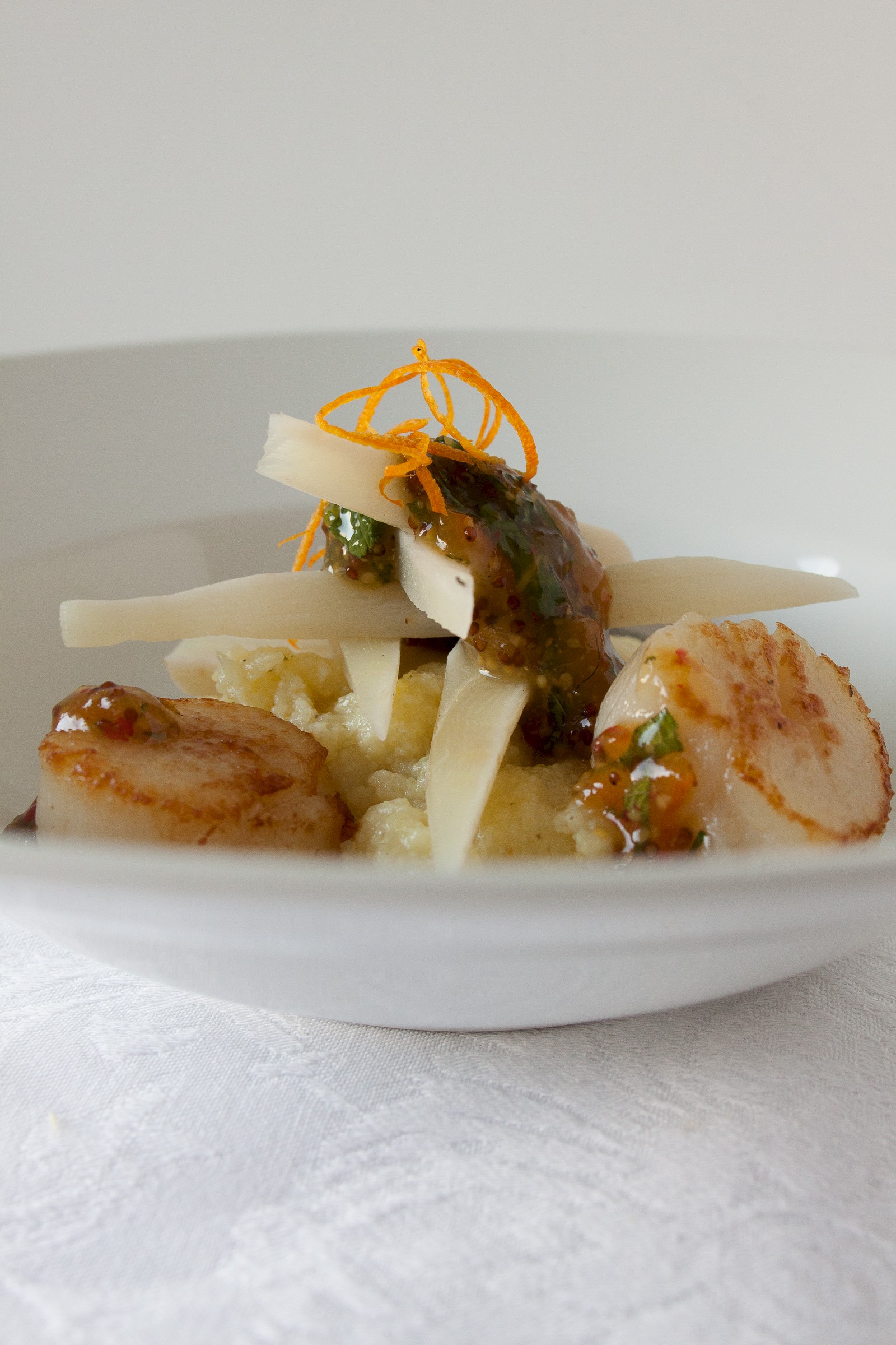 White polenta with scallops, black salsifies and bitter orange confit