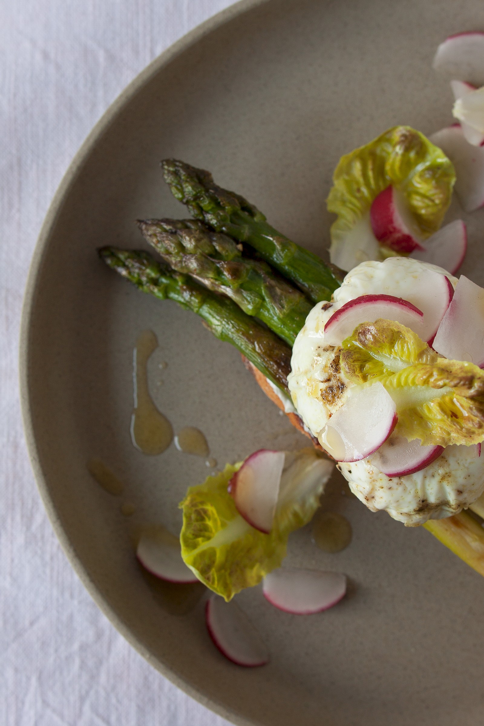 Asparagus crostini with goat cream cheese, poached egg and radishes