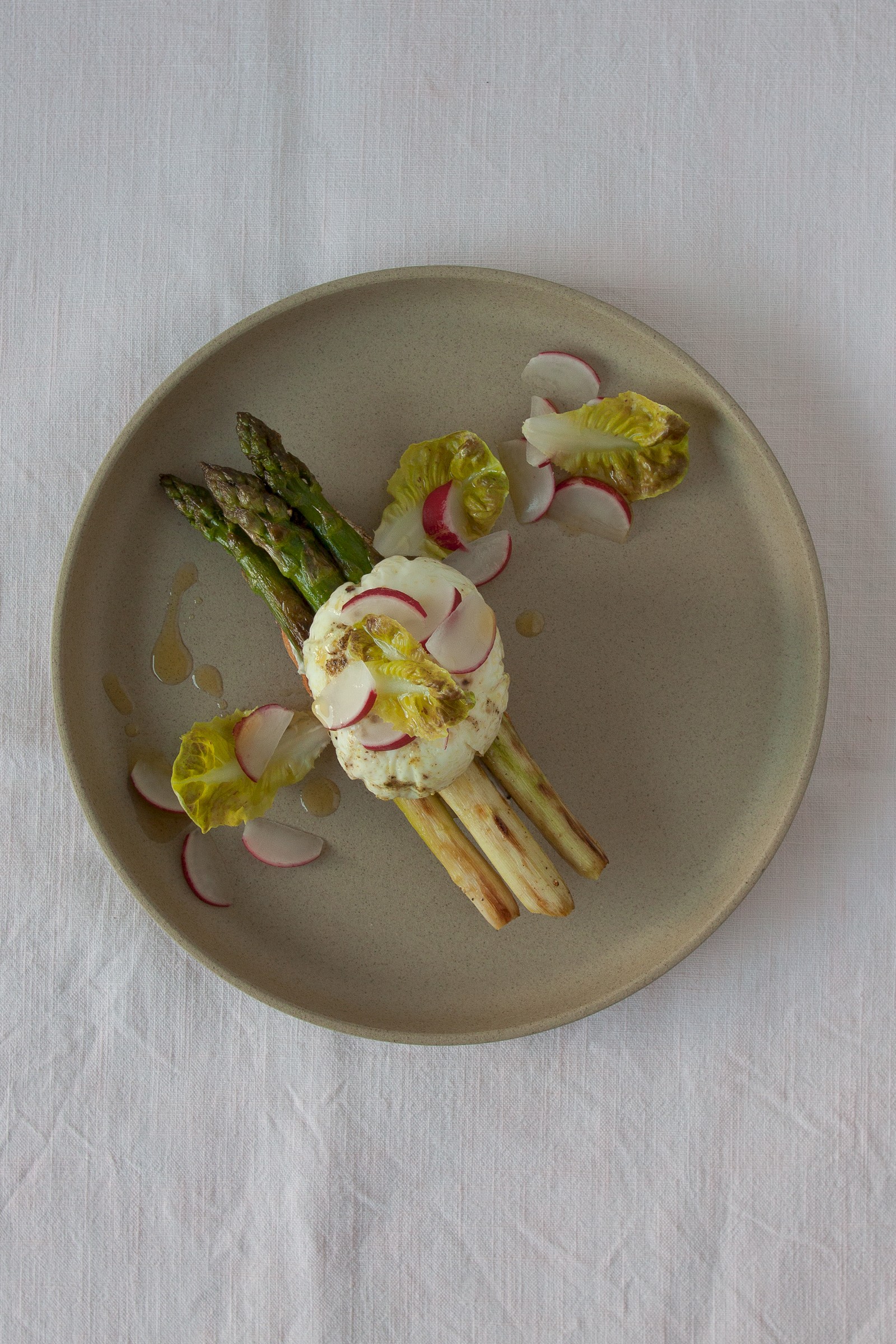 Asparagus crostini with goat cream cheese, poached egg and radishes