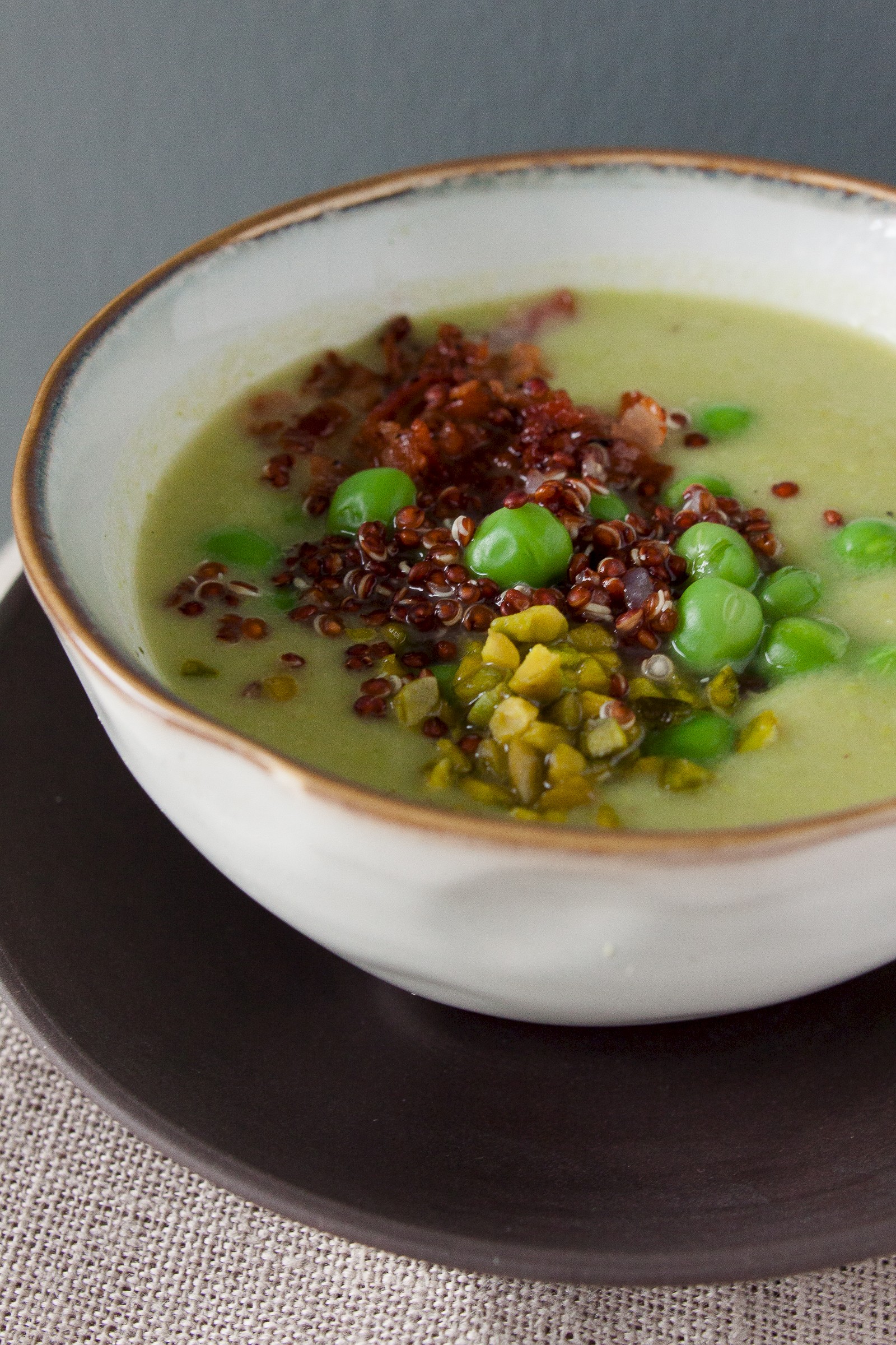 Parsnip pea soup with quinoa, bacon and pistachios
