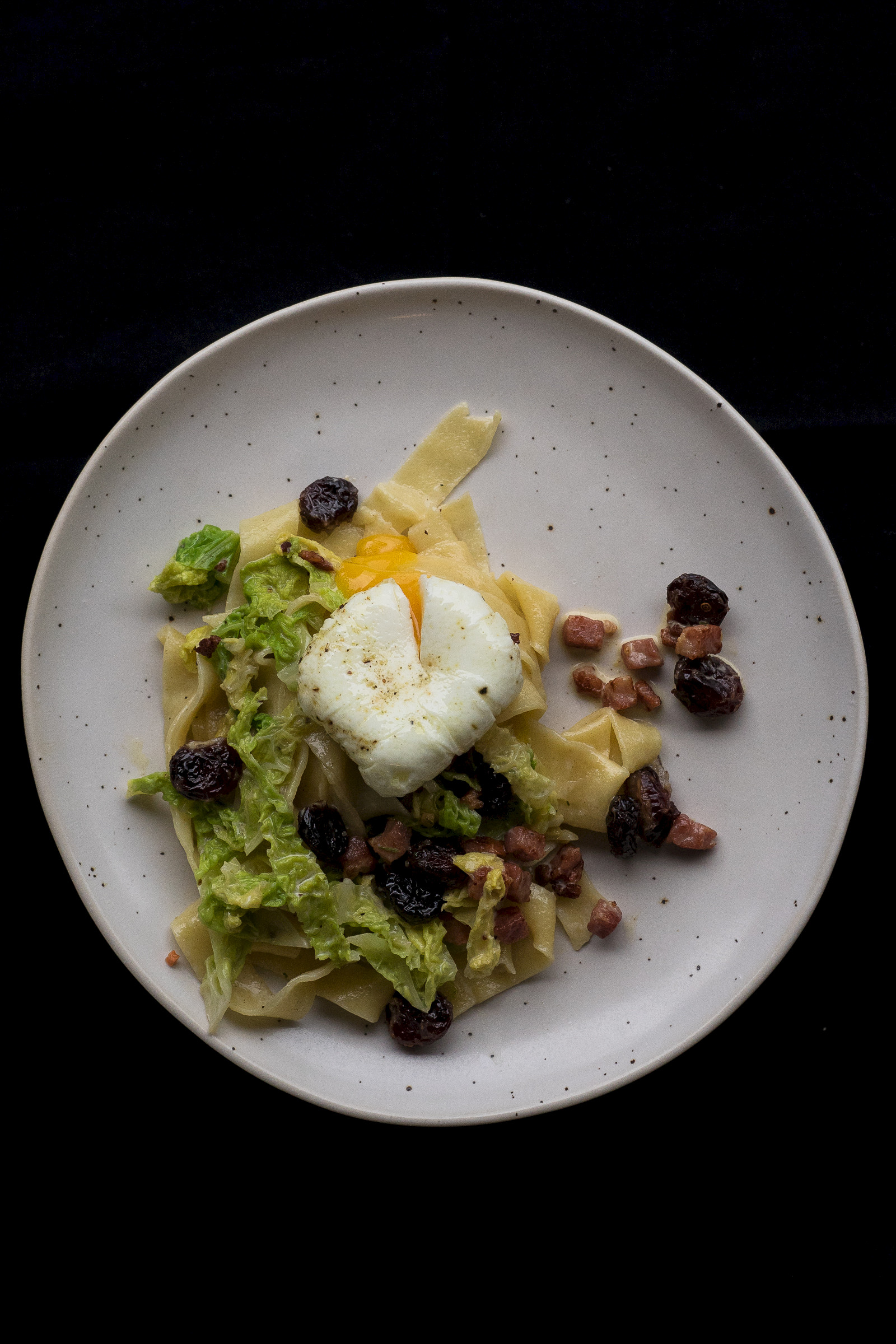 Tagliatelle with savoy cabbage, cranberries, bacon and poached egg