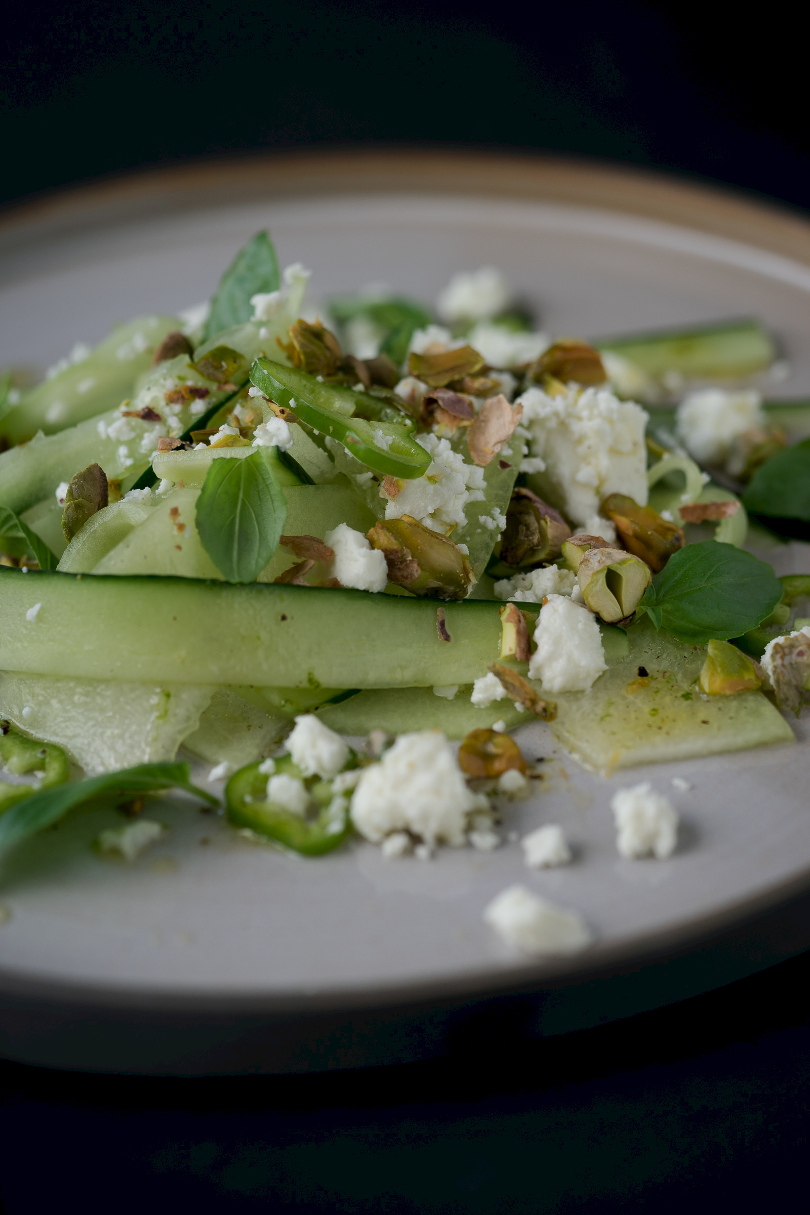 Honeydew cucumber salad with feta cheese, peperoncini and pistachios