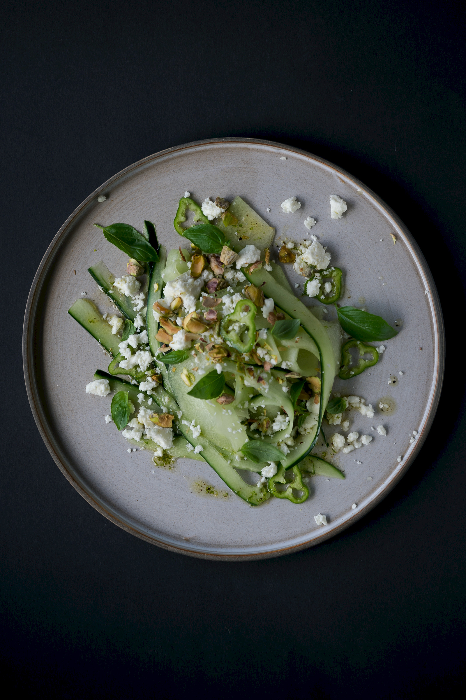 Honeydew cucumber salad with feta cheese, peperoncini and pistachios
