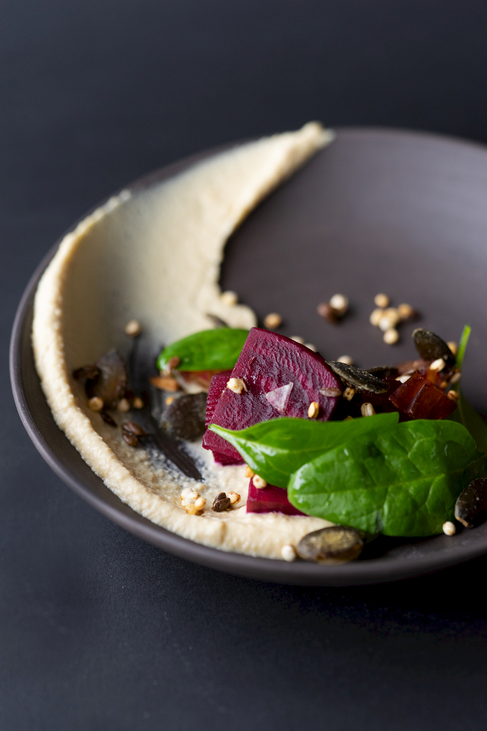 Humus with pickled beetroot, granola and leaf spinach