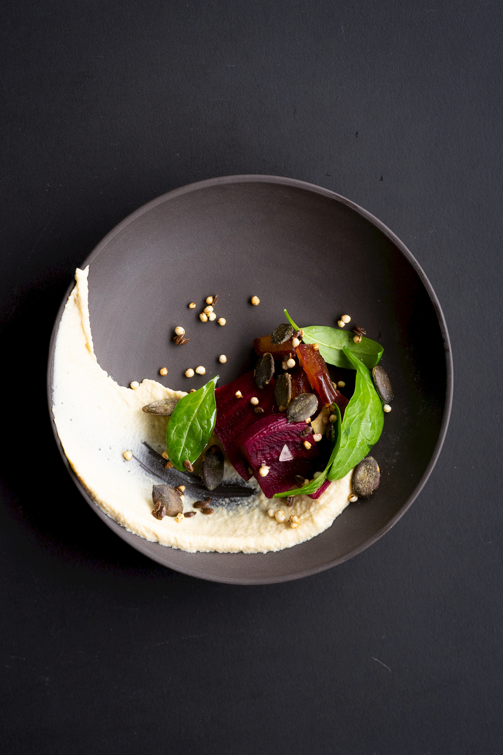 Humus with pickled beetroot, granola and leaf spinach