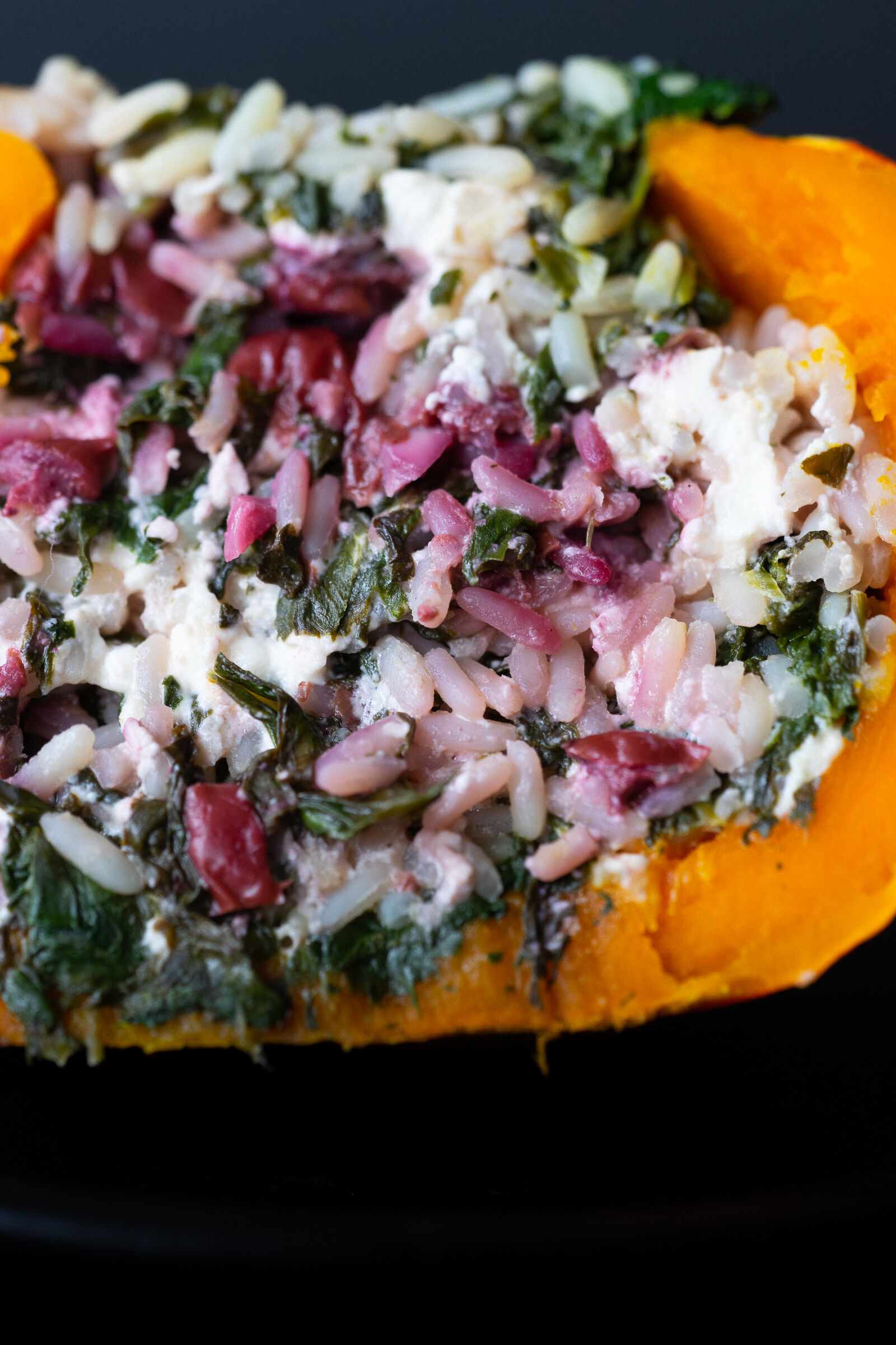 Pumpkin filled with rice, spinach and sour cherries