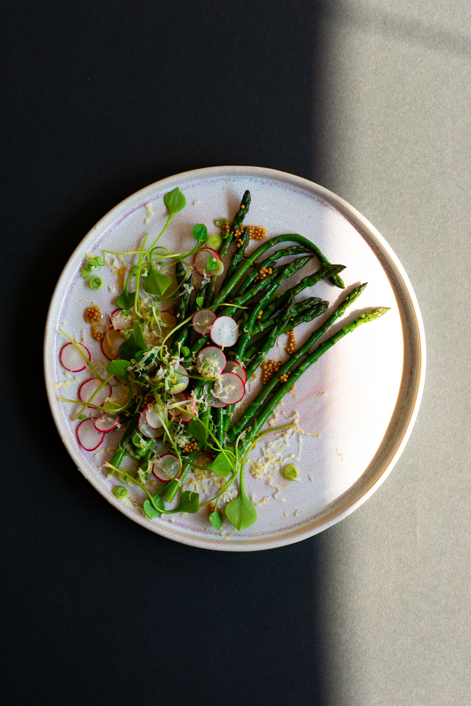 Asparagus salad with radishes, mustard seeds, scamorza and purslane