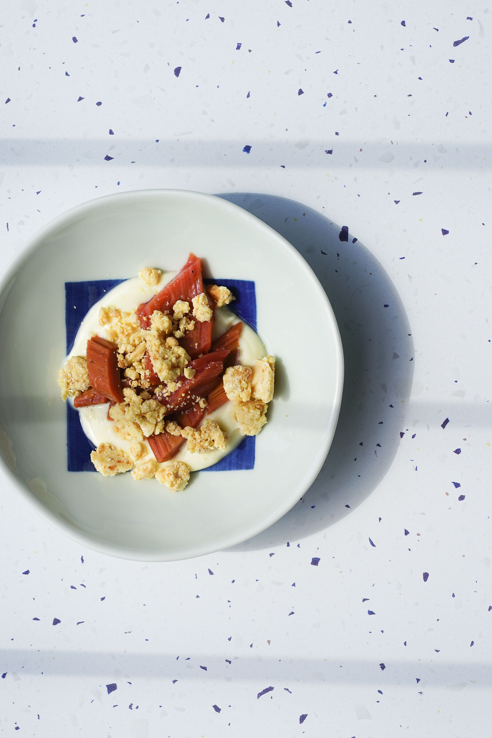 Poached rhubarb with lemon posset and macadamia milk crumbles