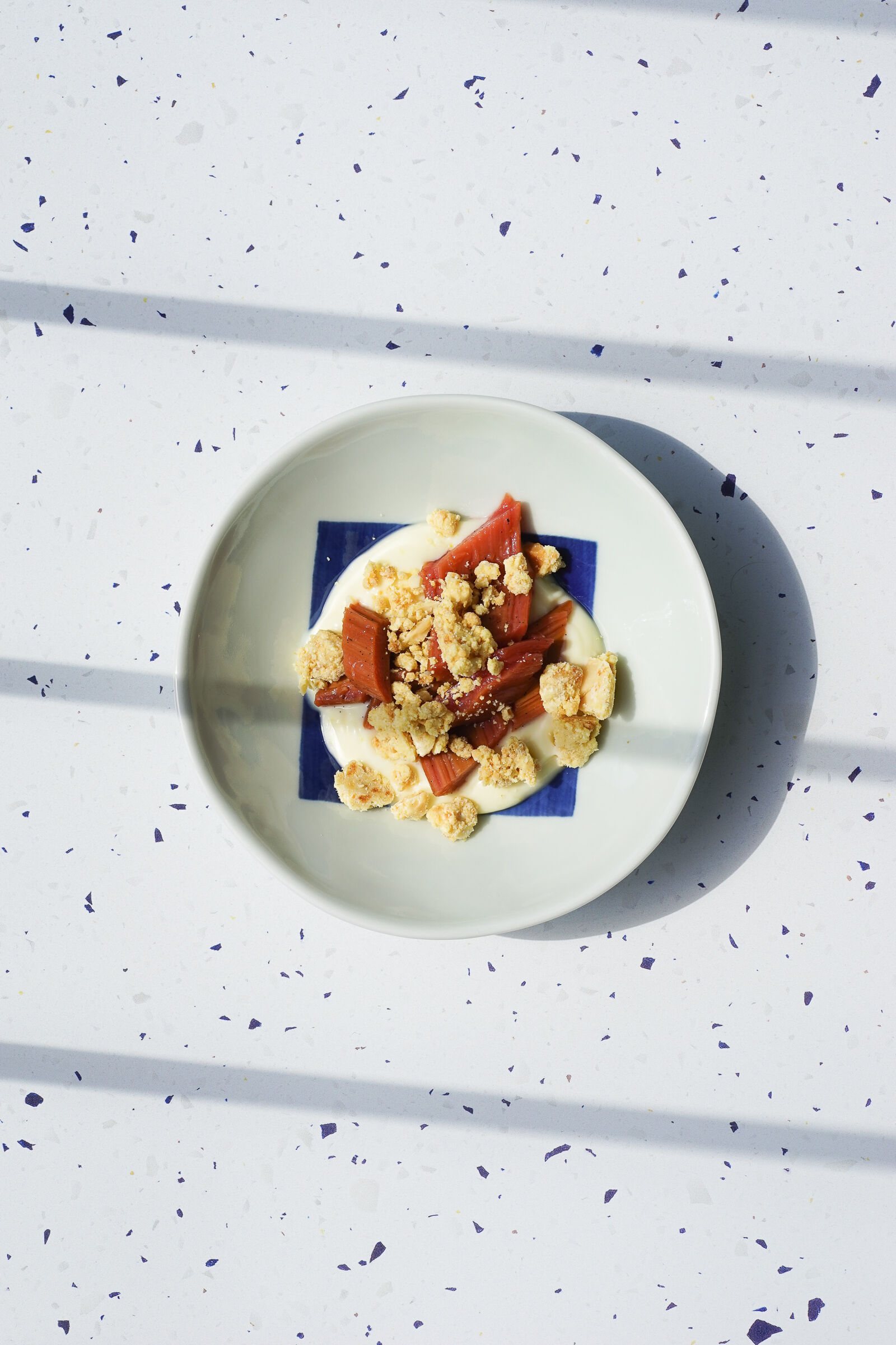 Poached rhubarb with lemon posset and macadamia milk crumbles